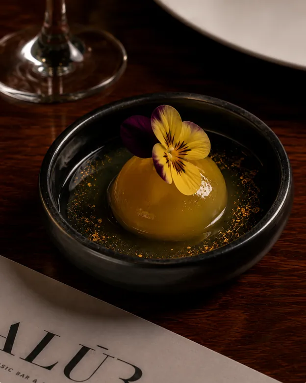 A Ball-O-Shot sphere plated with an edible flower
